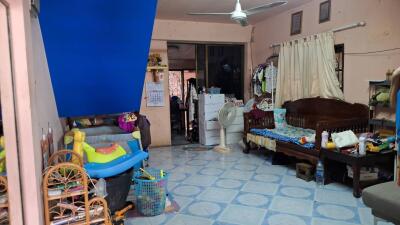 Cluttered living space with furniture and children