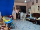 Cluttered living space with furniture and children's toys