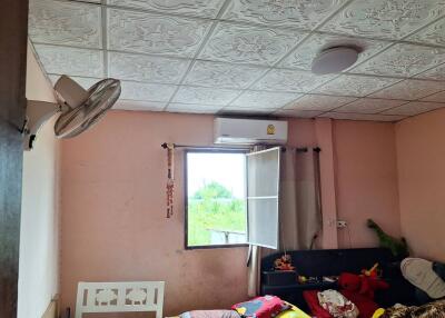 Cozy bedroom with a window, air conditioning unit, and decorative ceiling