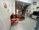 Living room with wooden furniture, stairway, and wall decorations