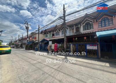 Street view of residential buildings with storefronts