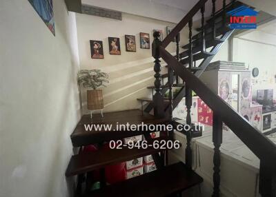 Indoor staircase with wooden steps and wall decorations