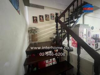 Indoor staircase with wooden steps and wall decorations