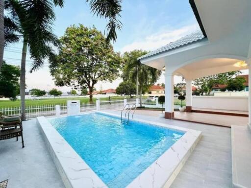 Outdoor pool area with surrounding patio and view of park