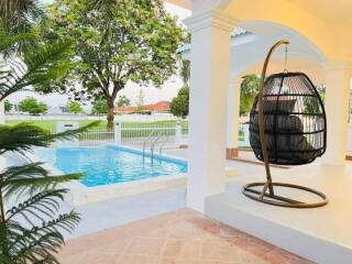 Outdoor patio with pool and hanging chair