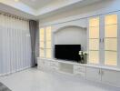 Modern living room with built-in entertainment unit and large window with curtains