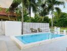 Outdoor swimming pool with patio and palm trees