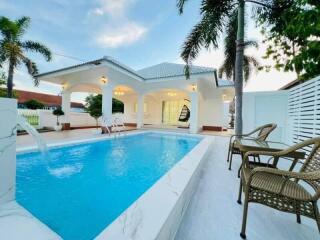 Outdoor pool area with patio and seating