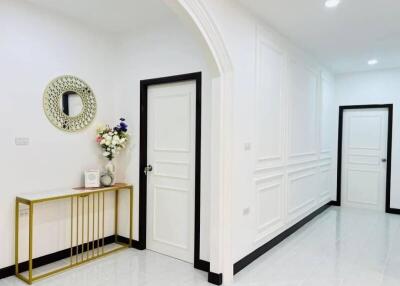 Modern hallway with white doors and elegant decor
