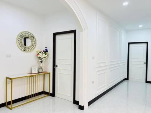 Modern hallway with white doors and elegant decor