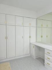 Spacious walk-in closet with built-in wardrobes and dressing table