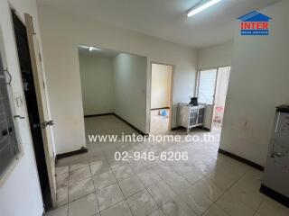 Common area with multiple doorways and tiled floor