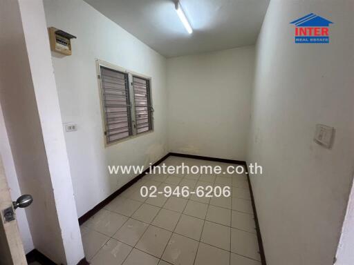 Small room with a window and tile floor