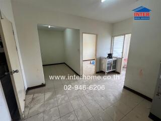 Main living area with tiled floor and access to other rooms