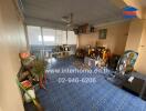 Spacious living area with blue tiled floor and various decorations