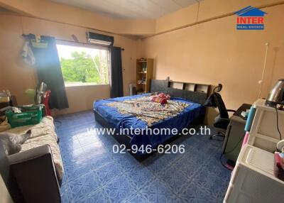 Spacious bedroom with double bed, window, and blue tiles