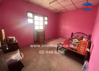 Bedroom with pink walls and a bed