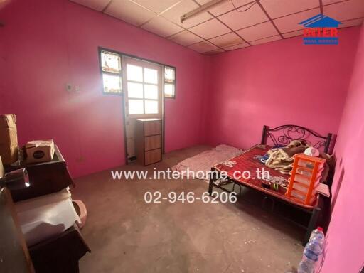 Bedroom with pink walls and a bed