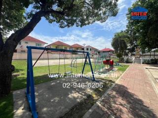 Playground with swings and climbing equipment in a residential area