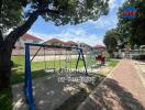 Playground with swings and climbing equipment in a residential area