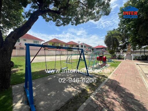 Playground with swings and climbing equipment in a residential area