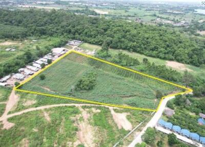 Aerial view of a large triangular plot of land surrounded by greenery