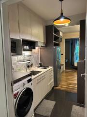 Modern kitchen with appliances and view towards living area