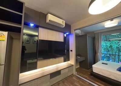 Modern bedroom with air conditioning, ample storage, and a large window