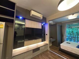 Modern bedroom with air conditioning, ample storage, and a large window
