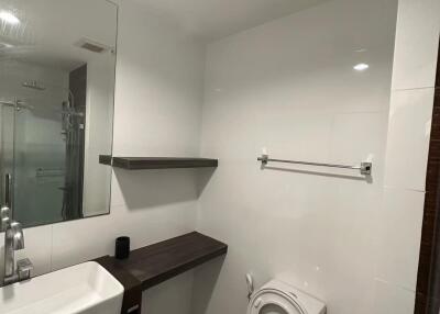 Modern bathroom with sink, toilet, and shower