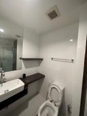 Modern bathroom with sink, toilet, and shower