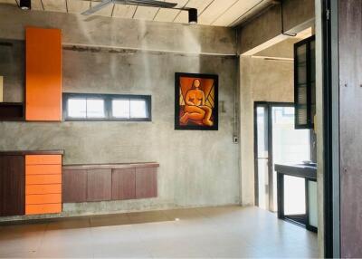 Modern industrial-style room with storage cabinets and wall decor