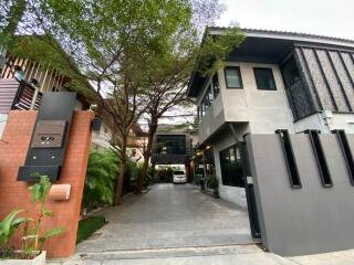 Modern house exterior with driveway and greenery