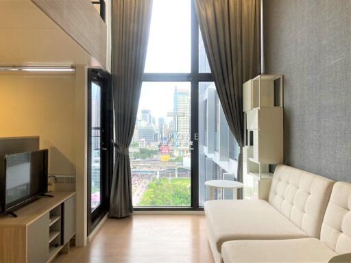 Modern living room with a large window and city view