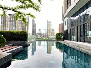 Modern apartment building with a rooftop pool and city view