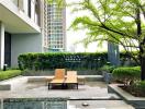 Modern outdoor area with lounge chairs and greenery