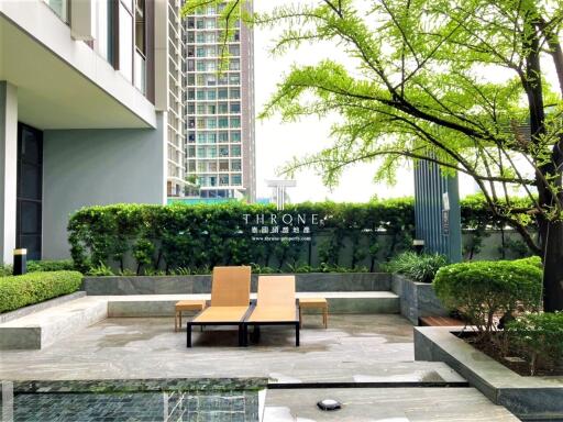 Modern outdoor area with lounge chairs and greenery