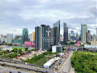 Skyline view of a city with modern high-rise buildings and a highway