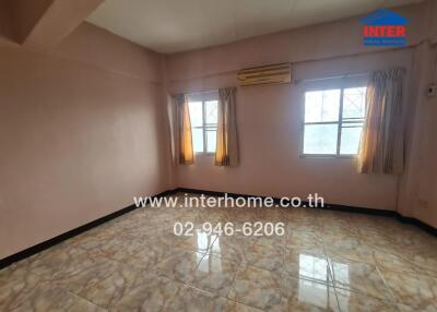 Empty bedroom with tiled floor and air conditioning