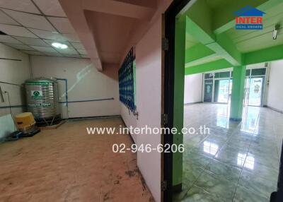 Empty commercial space with tiled floor and green accents