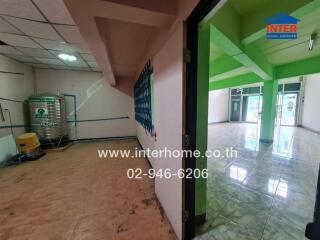 Empty commercial space with tiled floor and green accents