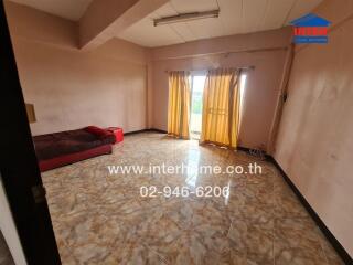 Spacious living room with sofa and large window