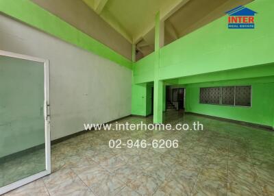 Spacious room in a building with green accents