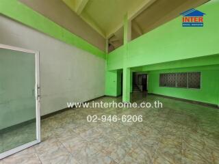 Spacious room in a building with green accents