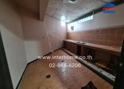 Empty kitchen with tiled walls and floor