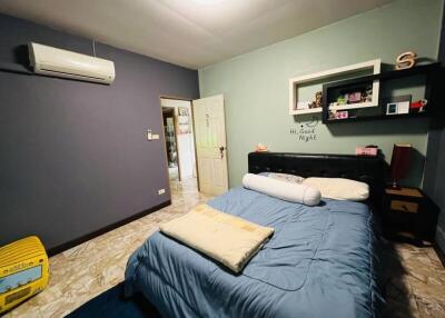 Spacious bedroom with blue walls and a double bed