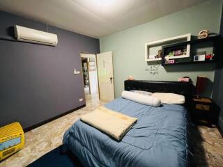 Spacious bedroom with blue walls and a double bed