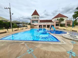 Outdoor swimming pool area with buildings in the background