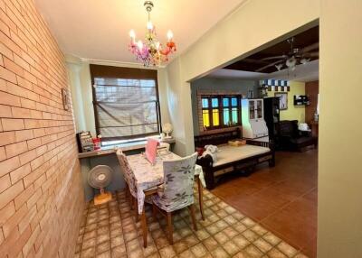 Dining area with decorative chandelier adjacent to living room