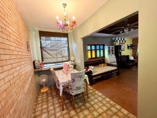 Dining area with decorative chandelier adjacent to living room